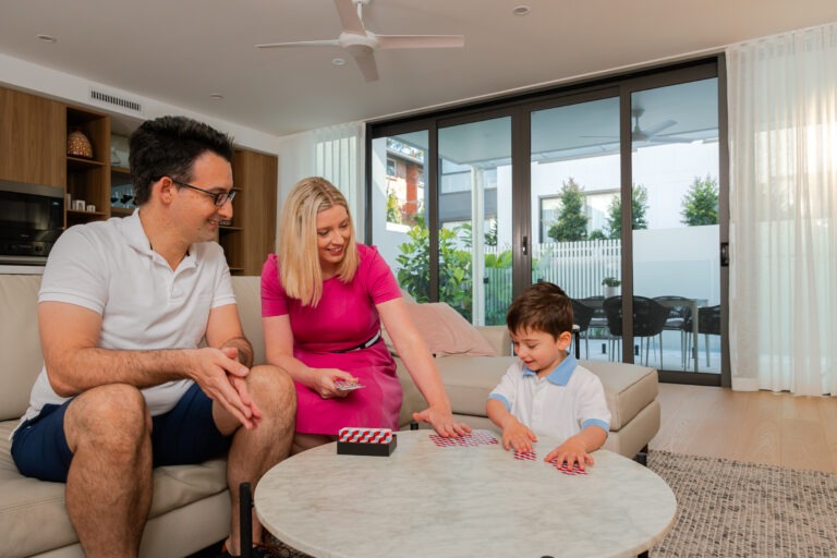 Family at home behind a Crimsafe security door
